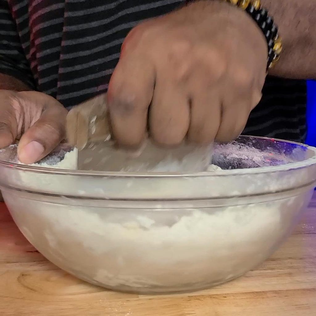 Flaky Pie Crust 2- Leslie Cooks. This picture depict a bowl of pie crust ingredients being mixed together.