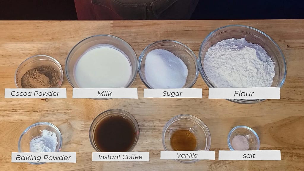 Double Chocolate Scones - Ingredients- This picture depicts cocoa powder, milk, sugar, flour, baking powder, instant coffee, vanilla, and salt.