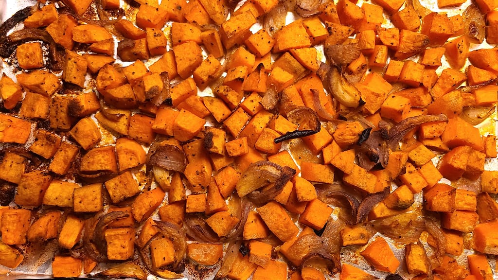 Roasted Sweet Potatoes on a Baking Sheet. They orange and and perfected roasted.