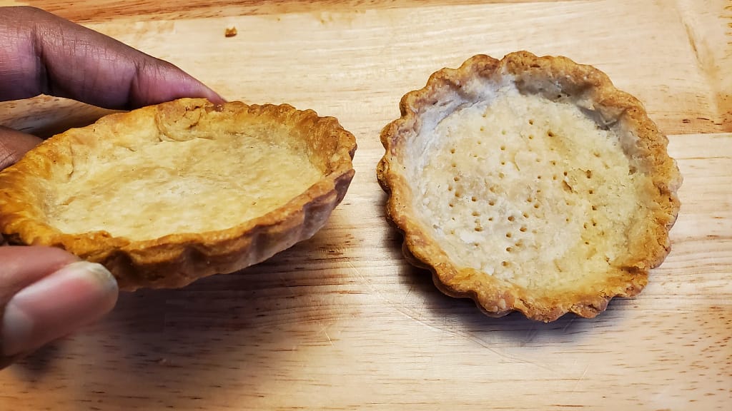 This image depicts a flaky tart crust that has been blind baked to prevent a soggy bottom. - Leslie Cooks