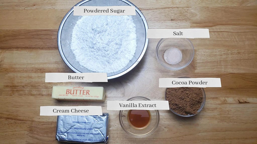 This image depicts most of the ingredients necessary to make chocolate cream cheese frosting as described by this blog post on lesliecooks.com