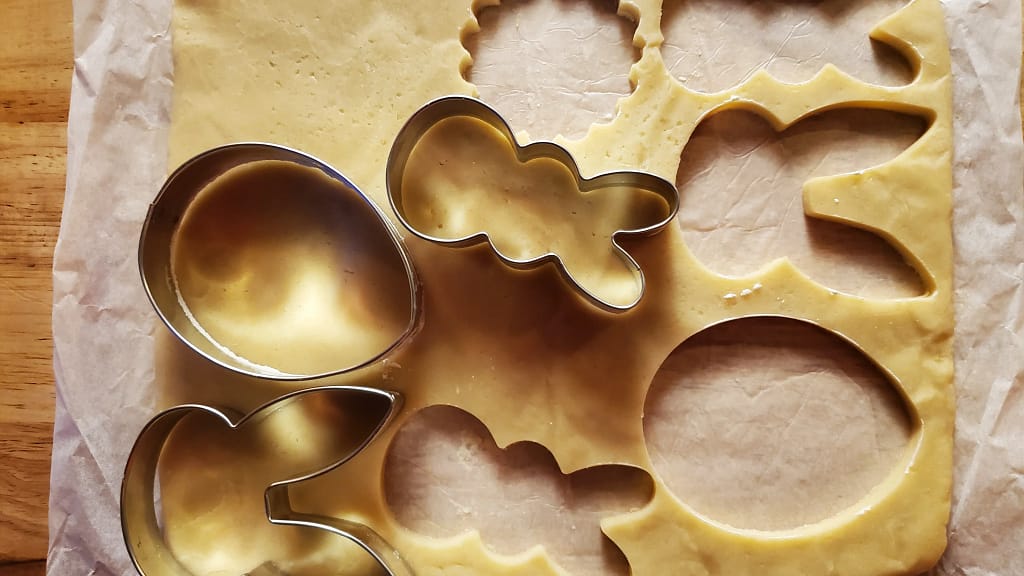 This image show the no spread sugar cookies being cut out using Easter themed cookie cutters like rabbits and egg shapes.