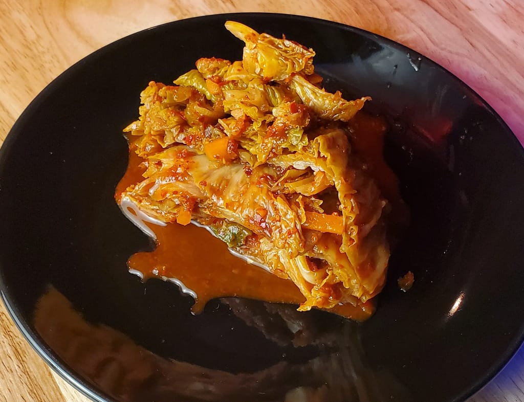 Kimchi - Leslie Cooks
This image depict Korean Kimchi sliced and served on a black plate. This show the result of following kimchi recipe posted on blog lesliecooks.com