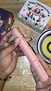 This photo depicts pink heart shaped cookie dough, glued together to form a pink log.