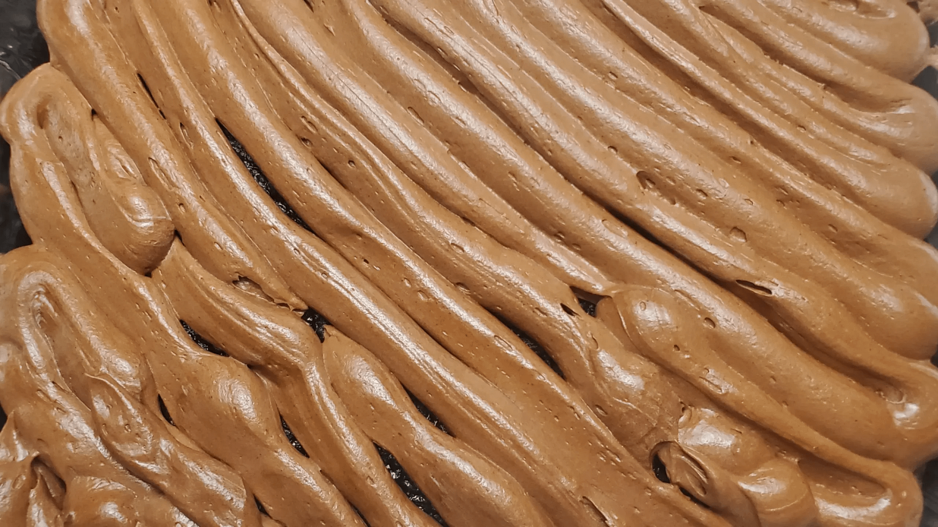 his image depicts Chocolate Cream Cheese Icing piped on a chocolate cake.