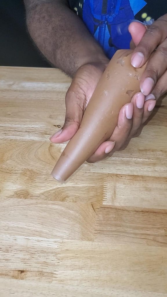 This image depict chocolate cream cheese frosting in a piping bag