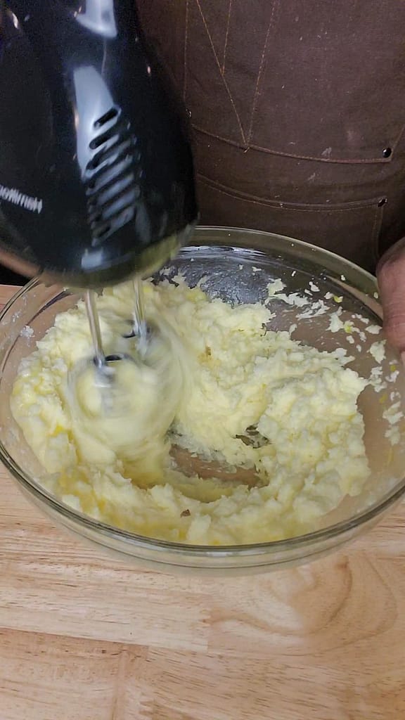 Beating butter and sugar until light and fluffy for the 5 flavor pound cake as described by this blog post on lesliecooks.com.
