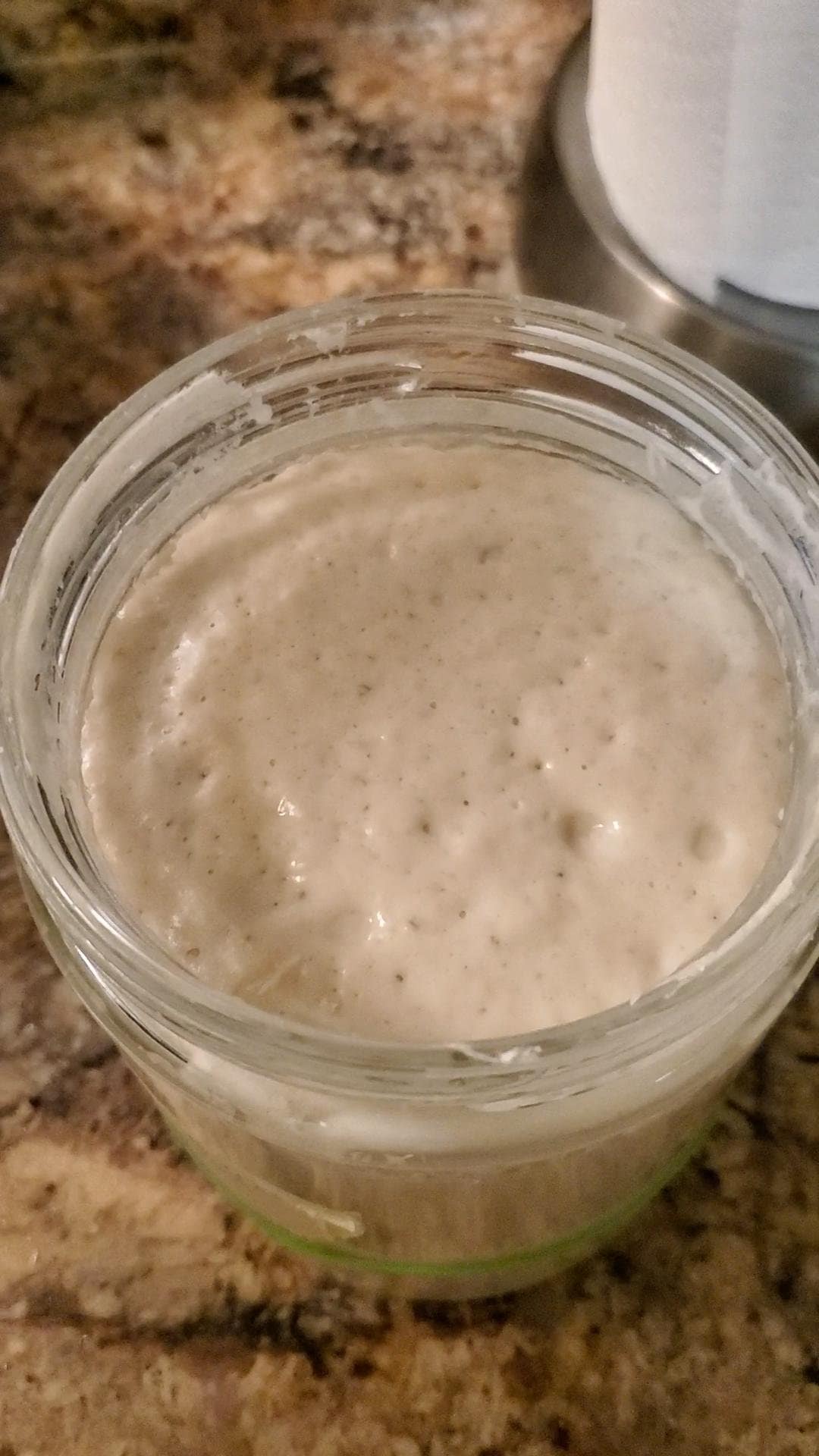 This image depicts sourdough starter a peek which means it has doubled in size.