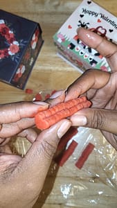 This photo depicts red heart shaped cookie dough, glued together to form a red log.