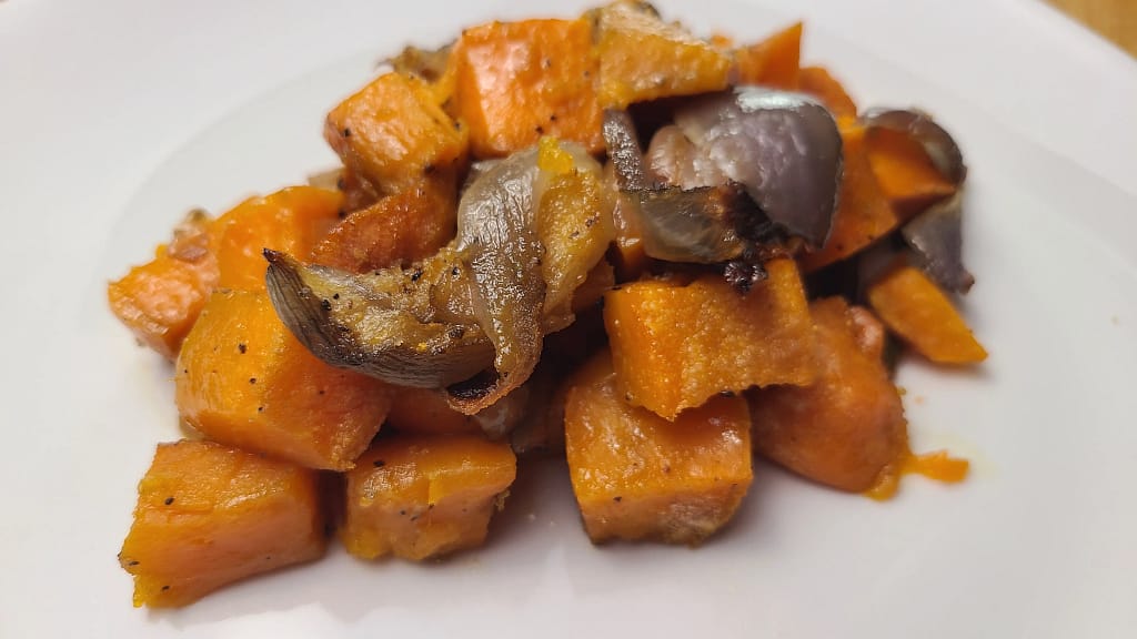 This image depicts roasted sweet potatoes and red onions on a white plate. This is what following the recipe on lesliecooks.com with yield. They look perfectly seasoned and cooked.