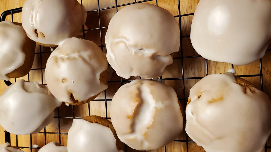 This image depicts pfeffernusse cookies that have been iced as describe by this pfeffernusse cookie recipe blog.