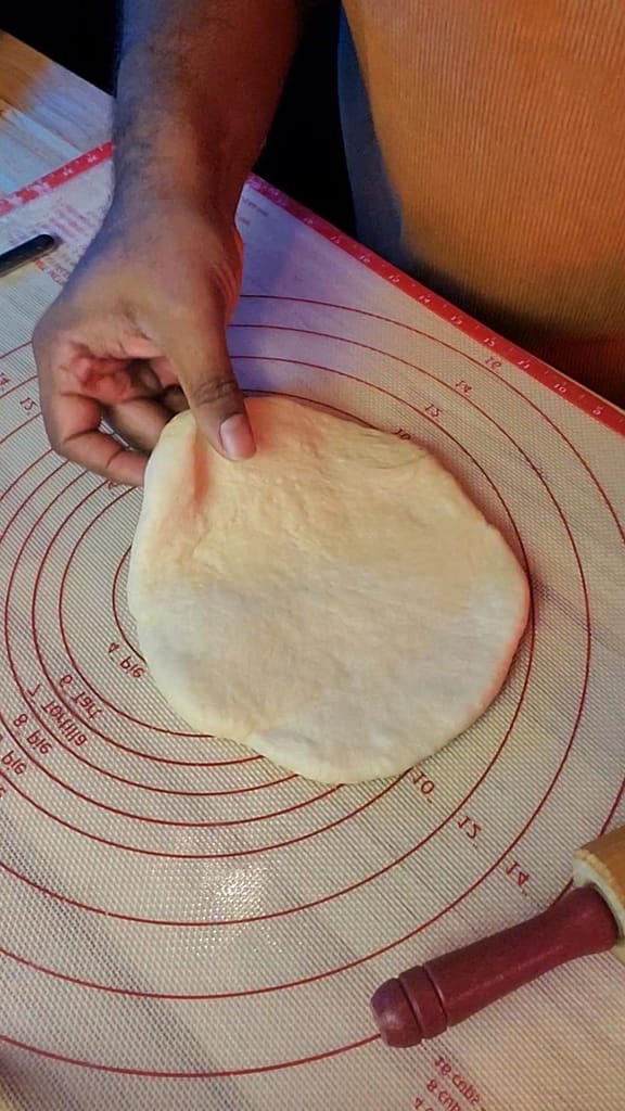 This image depicts yeast dough being stretched out on to a pastry mat with measured circles. This image is part of the instructions on how to form the braid found on lesliecooks.com.