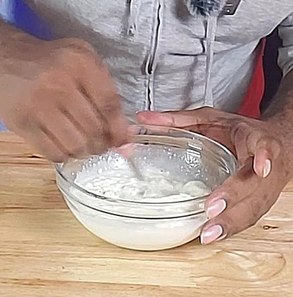 This image depicts the creamy easy broccoli salad dressing being stirred together as described by this blog post on lesliecooks.com.